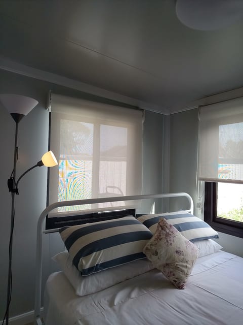 Main Bedroom: Sink into a plush queen-size bed with quality linens, overlooking a quiet, private floral garden. Fitted with dual day & blockout blinds, you can enjoy natural light & privacy during the day or total darkness for a great night's sleep.