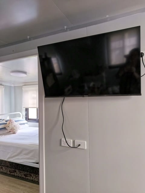 Smart TV Entertainment: Living area equipped with a compact Smart TV—perfect for logging into your favorite streaming accounts (Netflix, Stan, YouTube) and unwinding after a day of exploring.
