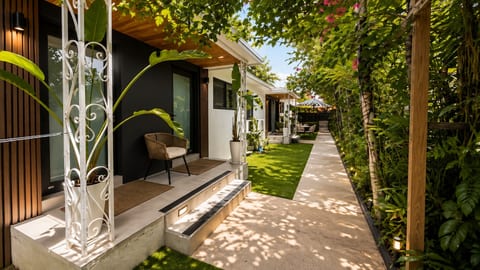 Entrance Oasis: Step into paradise with lush greenery and stylish seating for your relaxation!