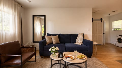 Living Room: Sun-drenched space with plush seating, ideal for relaxation and delightful meals!