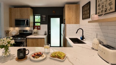 Kitchen: Sunlit elegance with modern appliances, perfect for whipping up Miami-inspired meals!
