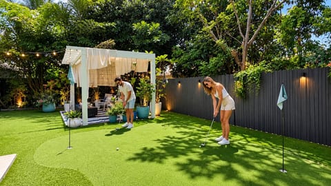 Golf Paradise: Perfect your swing on the lush green putting area, surrounded by tropical charm!