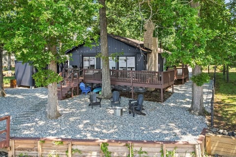 The backyard has many entertaining spaces including dining, lounging, grilling, firepit area, and the dock.