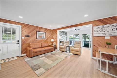 Open living room includes a leather sleeper sofa and leather swivel chairs to view the 55" SmartTV.