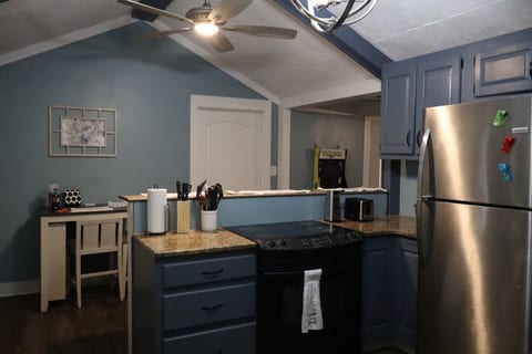 Bright, open kitchen with modern appliances and seating for family meals or game nights.