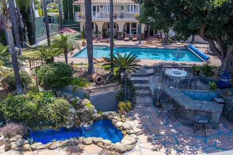 Backyard with lower patio, pond and bar