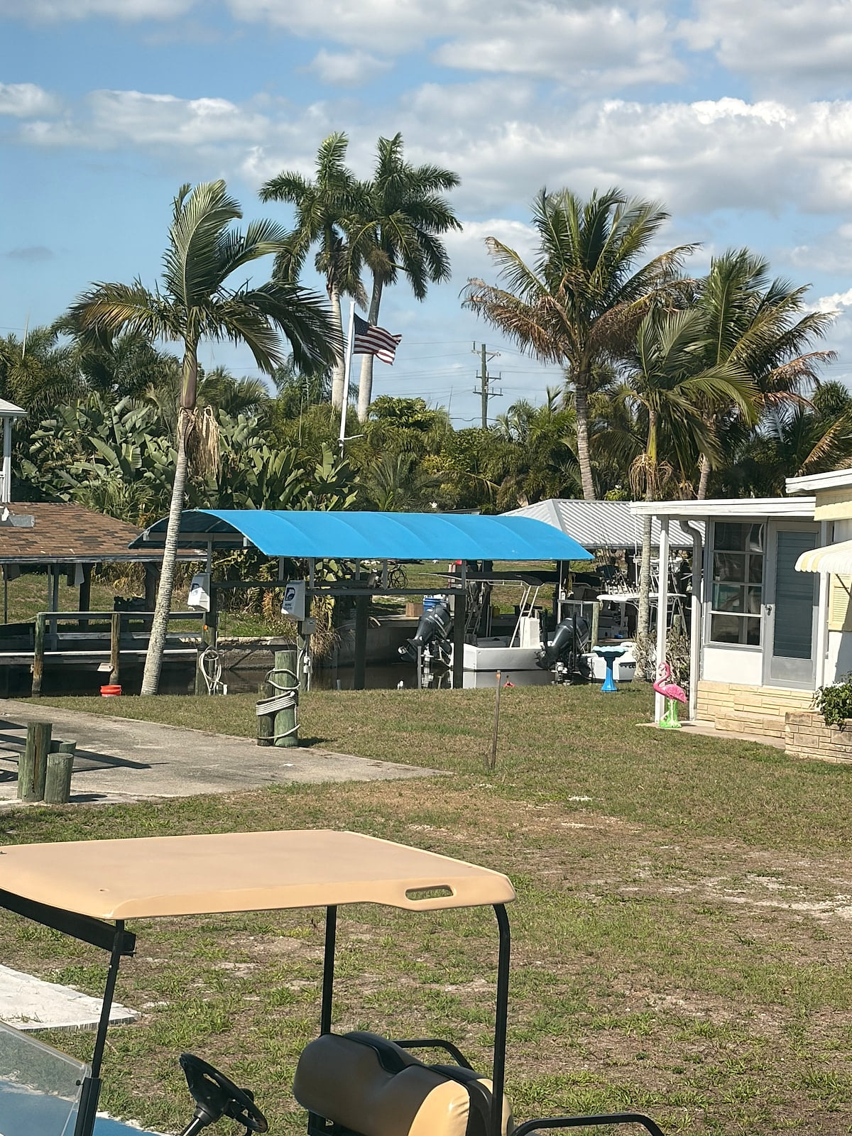 Our patio and beach is where the golf cart is. The orange flag is our deeded walkway down to the water. It’s so close!!