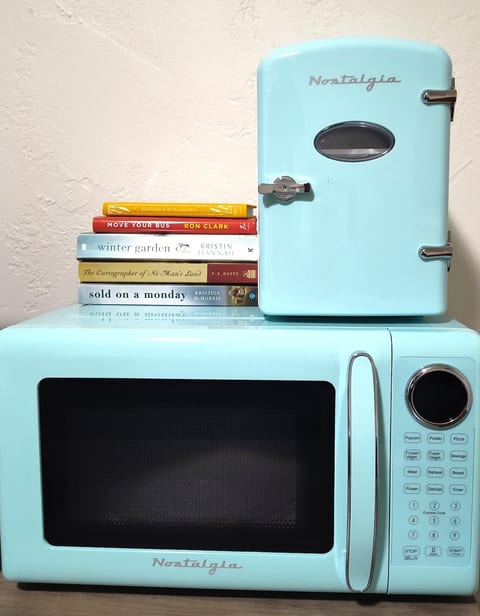 There is a personal size refrigerator (small - holds six cans - meant for a few snacks, etc) and a microwave for your convenience. These are brand new and retro style.