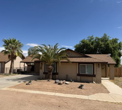 Front of house. Carport, extra long driveway, ample street parking