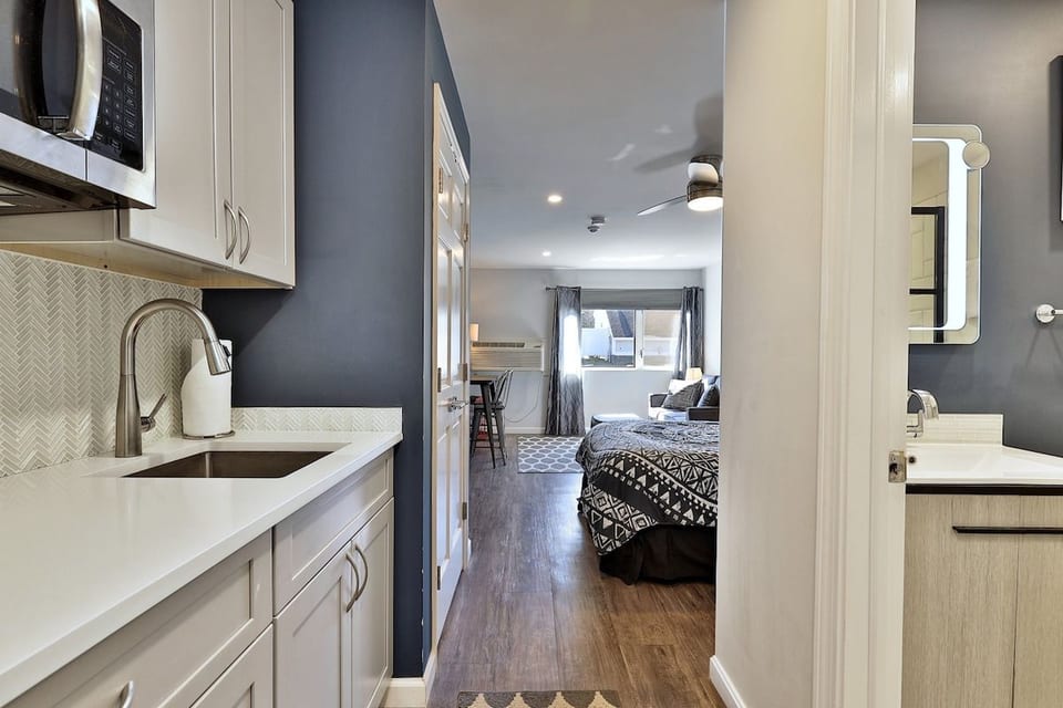 The kitchenette sits just off the open sleeping area, beside the bathroom.