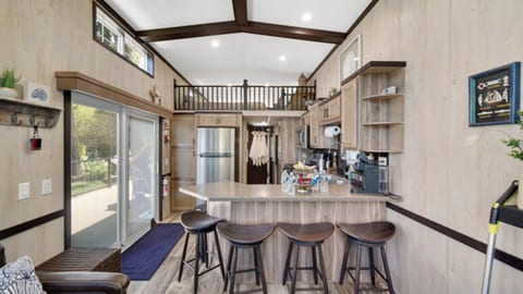 Kitchen with a sliding glass door, connecting the interior space to the tranquil lake setting just outside.