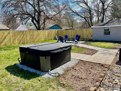 Fully fenced in back yard with hot tub & fire pit!