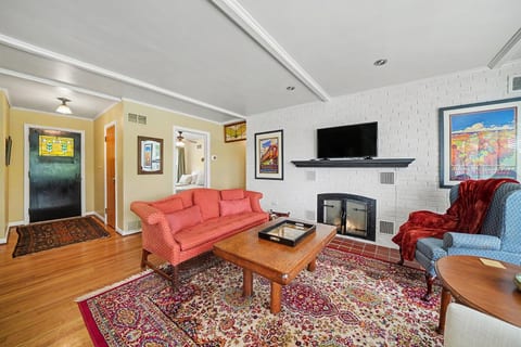 Comfortable living room with inviting seating, perfect for relaxing after a day out (decorative fireplace not for guest use).