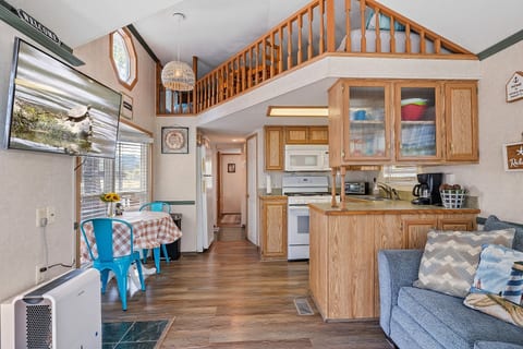 Functional kitchen featuring a small breakfast table for two, ideal for quick meals or morning coffee.