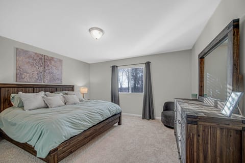 Spacious master bedroom with a comfortable king bed.