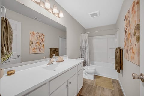Full bathroom featuring a tub and shower with plenty of space.