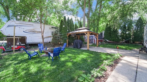 Outdoor fire pit area with a covered pavilion nearby, perfect for gatherings, meals, or relaxing under the stars.