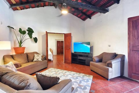 The spacious living area includes a TV with streaming services and cozy furnishings.
