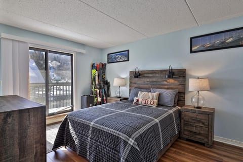 The queen bed sits beside sliding doors to your private balcony.
