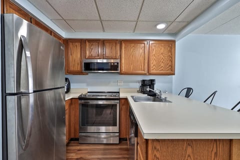 The kitchen has a refrigerator, range and microwave for preparing meals back at the condo.
