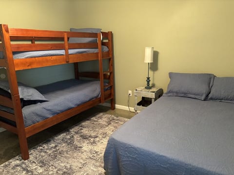 This room contains one full bed and one bunk bed consisting of two twin beds.
