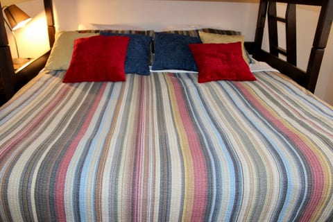 The king bed sits beneath the single bed in the condo's one bedroom.