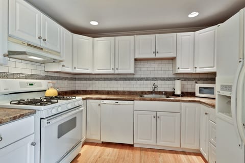 Prepare meals in the kitchen, with a gas stove and dishwasher for cleanup.