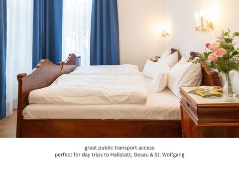 Sleep like royalty in our heritage suite. Featuring a 200x193 cm bed with premium Schranz linens, this carpenter-modernized antique bed offers ultimate comfort. Ideal for unwinding after a day trip to nearby Hallstatt.