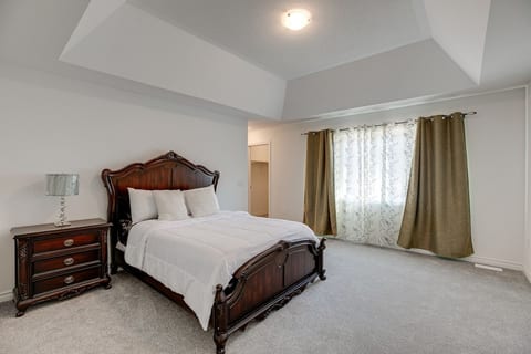 Bedroom #2:  Spacious room with solid wooden bed and walk-in closet