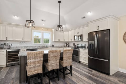 A bright and airy kitchen and sitting area in a refreshing white-themed design.