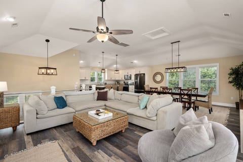 A cozy retreat: L-shaped sofa and smart TV in the elegant white-themed living room.