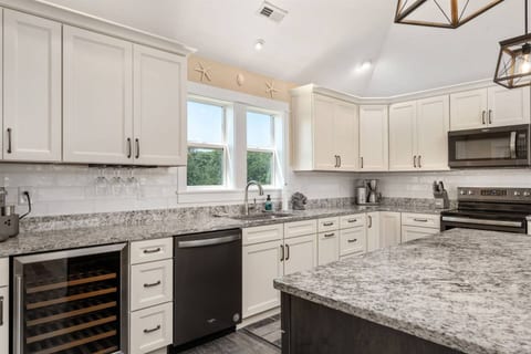 Simplicity and style converge in the white-themed kitchen.