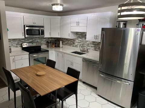 Newly renovated kitchen, fully equipped with microwave, oven, various coffee makers, dishwasher, and big fridge. Table folds up when not in use, seats 6.