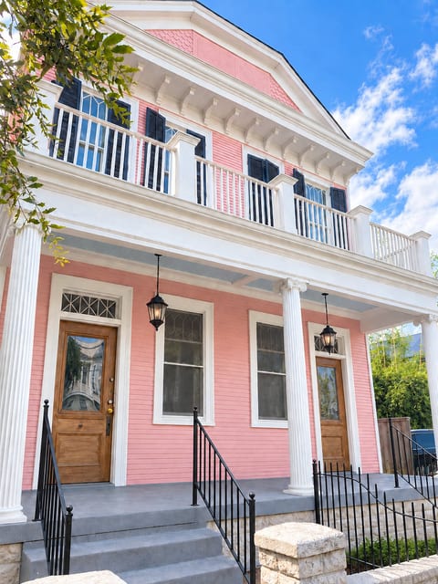 Charming pink historic home with porch, balcony, and classic Southern style
