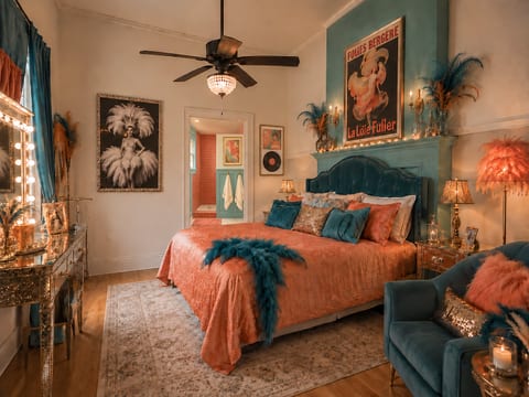 Glam vintage-inspired suite with luxe teal accents and en suite bath