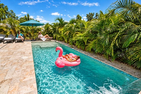 Private tropical pool oasis with loungers, shade, and resort-style vibes