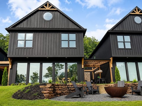 Back of the house facing the lake with a wall of windows for an expansive lake view!