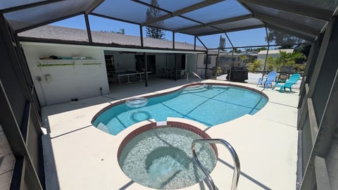 Backyard Oasis: Dive into relaxation with a sparkling pool and spa, surrounded by lush greenery!