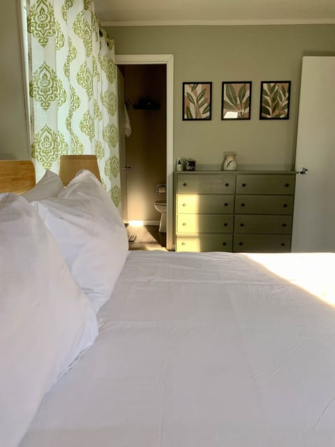 Bedroom 1 with en-suite half bath and access to deck.