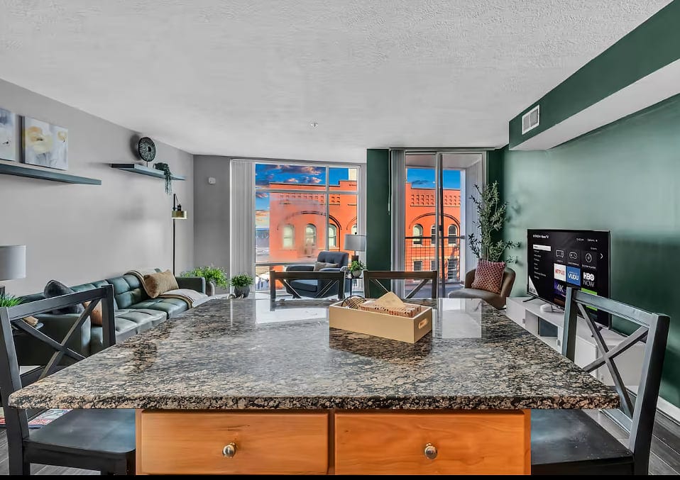 Bright urban living space with granite island and stunning city views