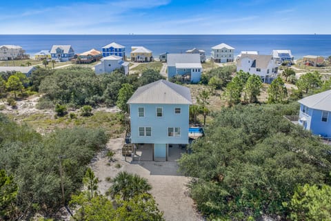 Count the rooftops between you and the water — that's the walk to the beach. Your house sits right there in the middle of it, pool tucked underneath.