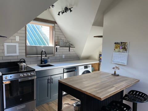 Full kitchen, stainless steel appliances
Washing machine and drying rack.