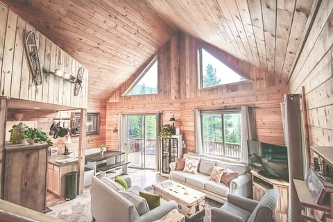 The Overlook Lodge's centerpiece: the main room has tall ceilings, beautiful natural wood, and every amenity you need to curl up, kick back, and host your friends and family no matter the season.