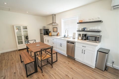 Fully stocked ktichen with dishwasher, microwave, and stove.