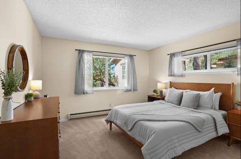 Comfortable bedroom with a queen bed, closet, dresser, and plenty of natural light.