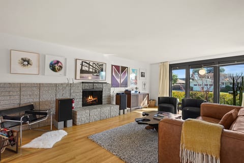 Gather and unwind in the spacious living room featuring comfortable seating, a Smart TV, and an inviting atmosphere perfect for relaxing with family and friends.