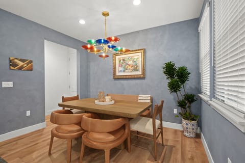 Inviting dining area with seating for seven, natural light, and a colorful statement chandelier. A comfortable space for shared meals, morning coffee, or a glass of Napa Valley wine.