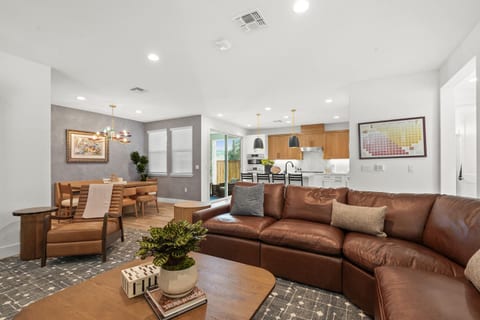 Spacious open concept living area with comfortable seating, a Smart TV, and easy flow into the dining area and full kitchen. Perfect for relaxing and spending time together.