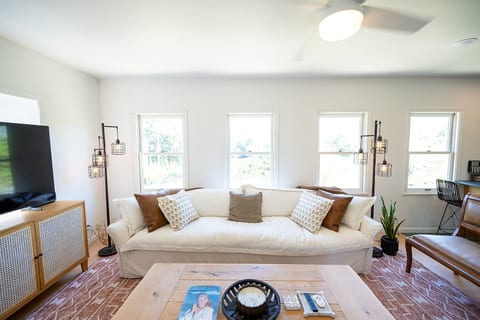 Bright and comfortable living space designed for relaxing after a day in Napa. Smart TV and large sofa couch and bench. Board games included for a night in.