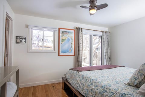 Largest bedroom with a patio entrance and small, private half bathroom